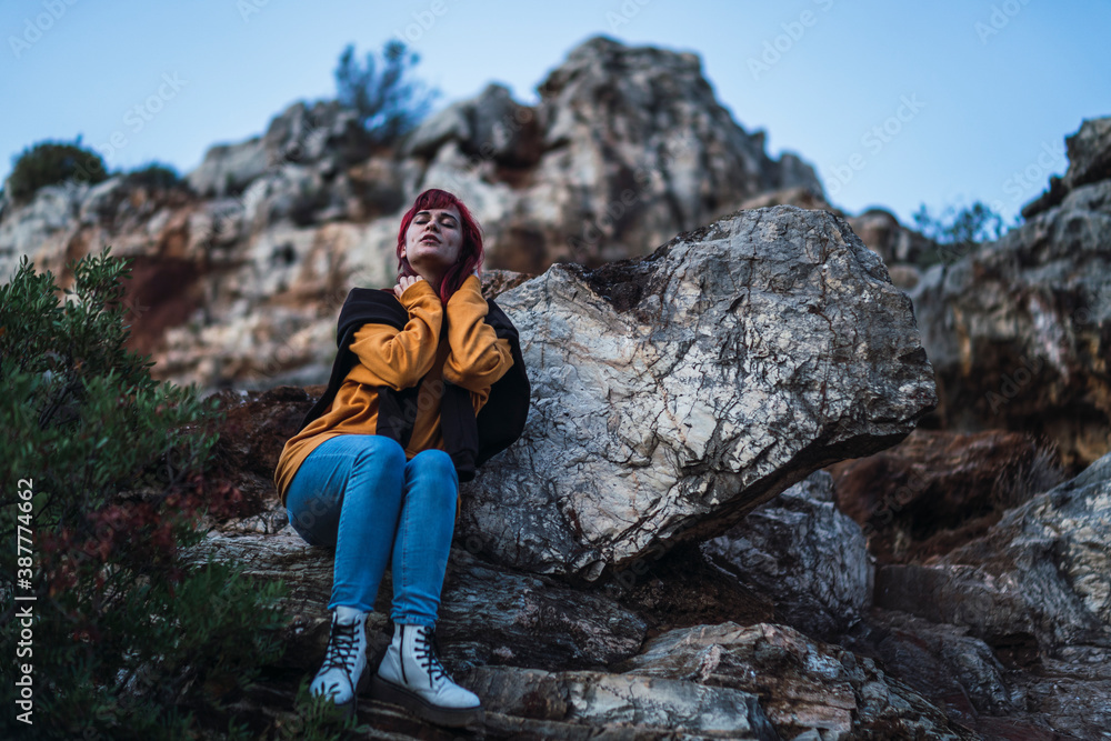 Naklejka premium Chica peliroja en parque natural tomando fotogarfías
