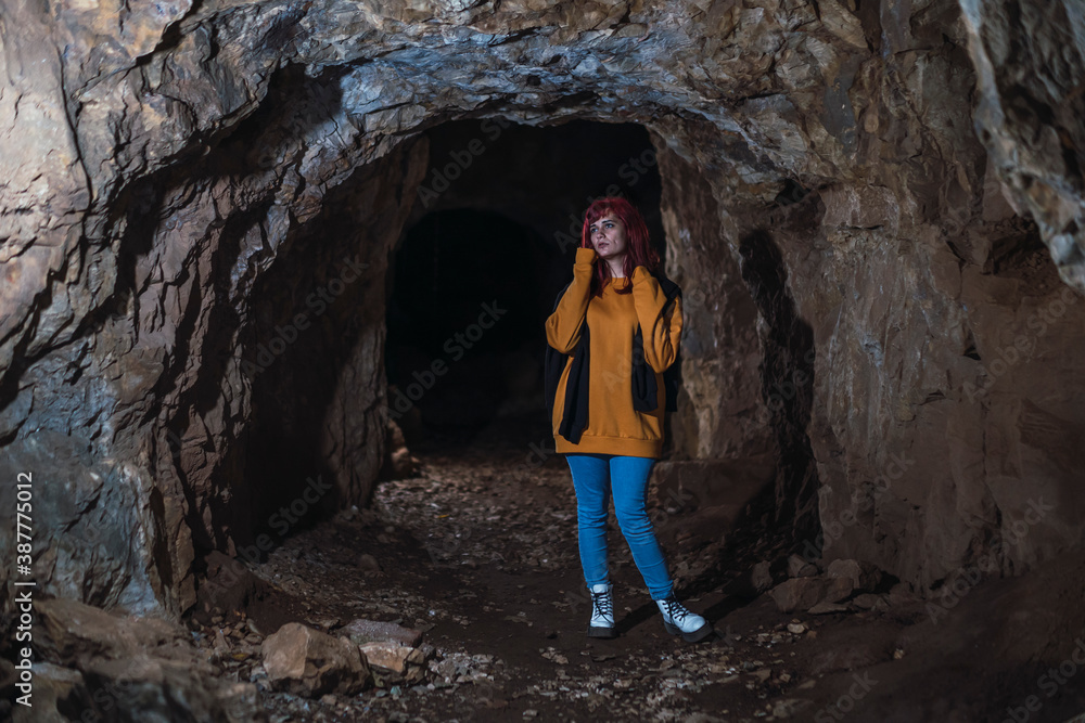 Chica joven peliroja en cueva