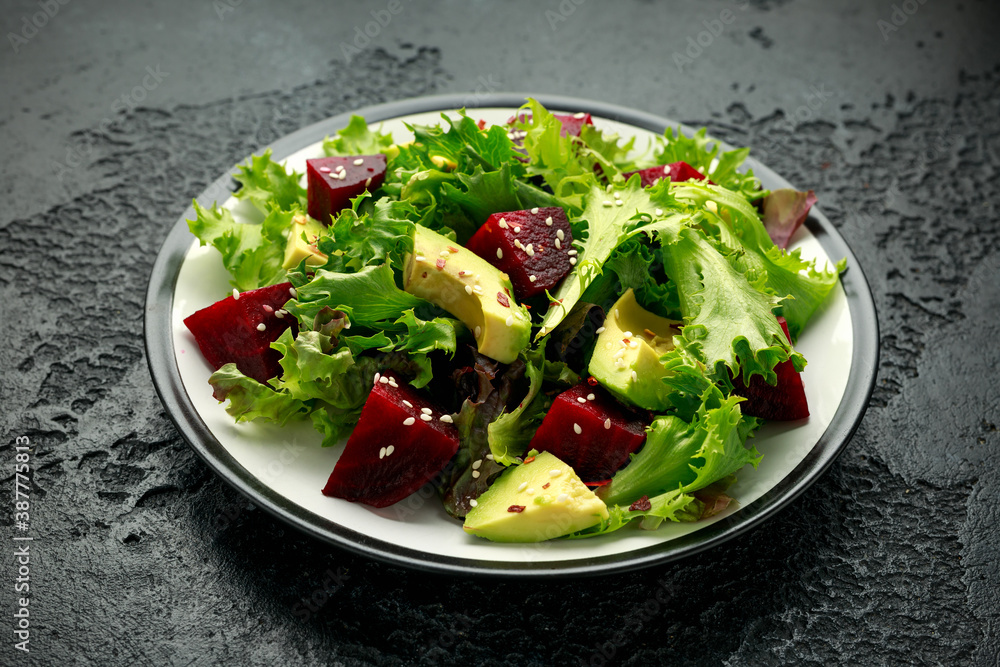 Vegetarian avocado and beet salad in plate. Healthy vegan food