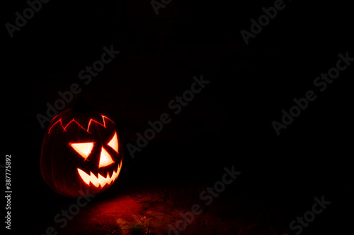 Spooky Halloween pumpkin lantern at night in the darkness