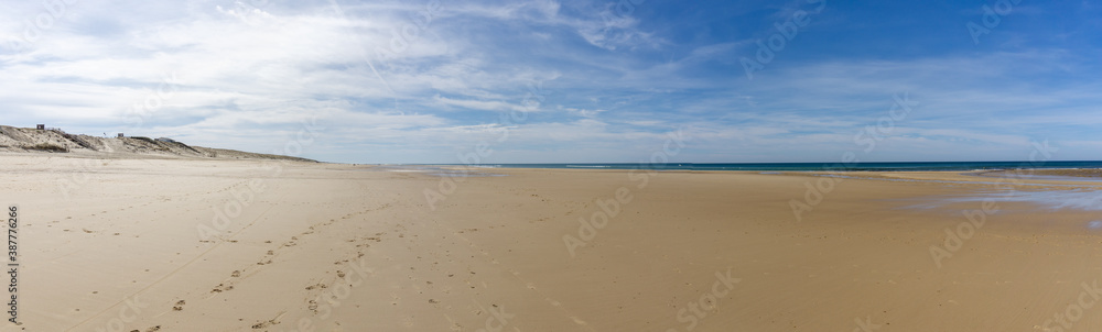 wide empty beach and sand dunes on the Atlantic Ocean coast in France