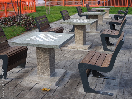 Concrete chess table for outdoor play. Chess playground in the city park. Contemporary concrete architecture and public space decoration