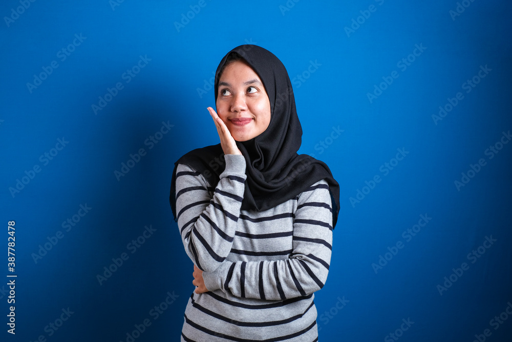 Portrait of Asian muslim student college girl smiling and thinking gesture Portrait of Asian muslim student college girl smiling and thinking gesture