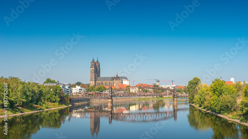 Panoramic view over downtown of Magdeburg  old town  Elbe river  bridges and Magnificent Cathedral at early Autumn  Germany  at sunny day and clear blue sky...