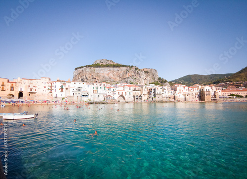 Fototapeta Naklejka Na Ścianę i Meble -  Characteristic view of the coastal city of Cefalù near Palermo in Sicily. It has a cristal clear blue water and nice old houses in front of the sea 