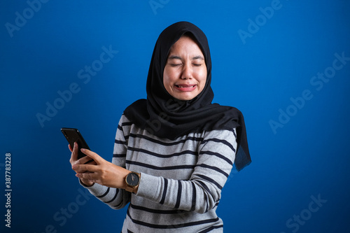 Asian Muslim Teenage Girl Crying Sad When Receiving Bad News On Phone