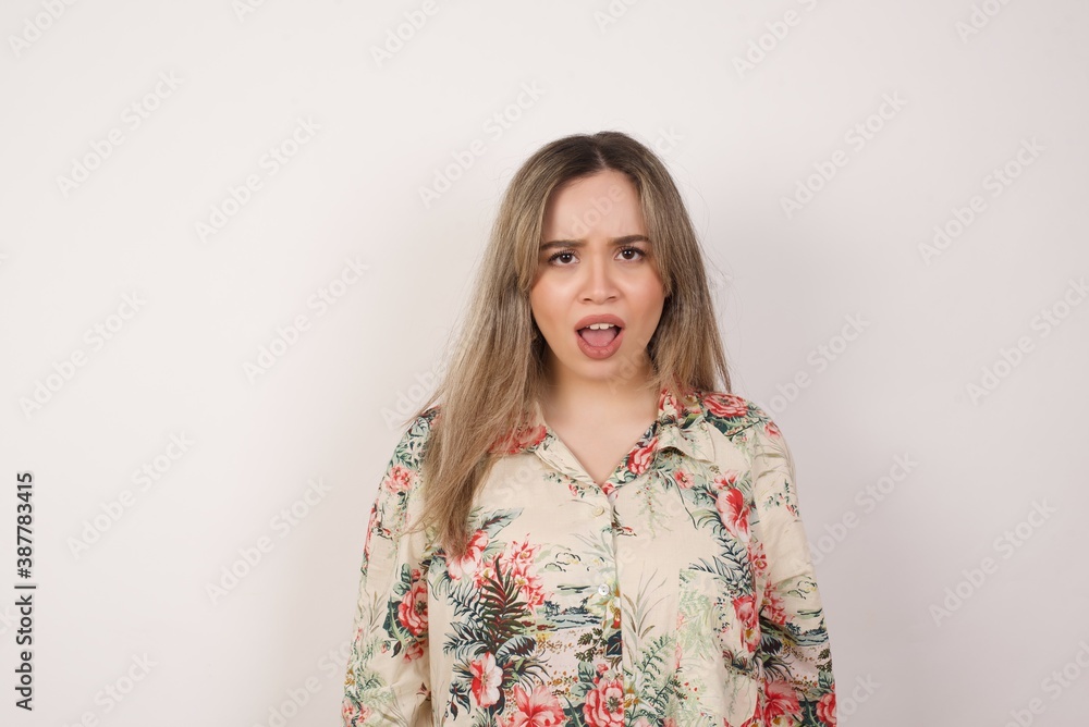 Attractive young woman having stunned and shocked look, with mouth open and jaw dropped, listening to friend's story in full disbelief, exclaiming: Wow, I can't believe this. Surprised girl. Shock Attractive young woman having stunned and shocked look, with mouth open and jaw dropped, listening to friend's story in full disbelief, exclaiming: Wow, I can't believe this. Surprised girl. Shock