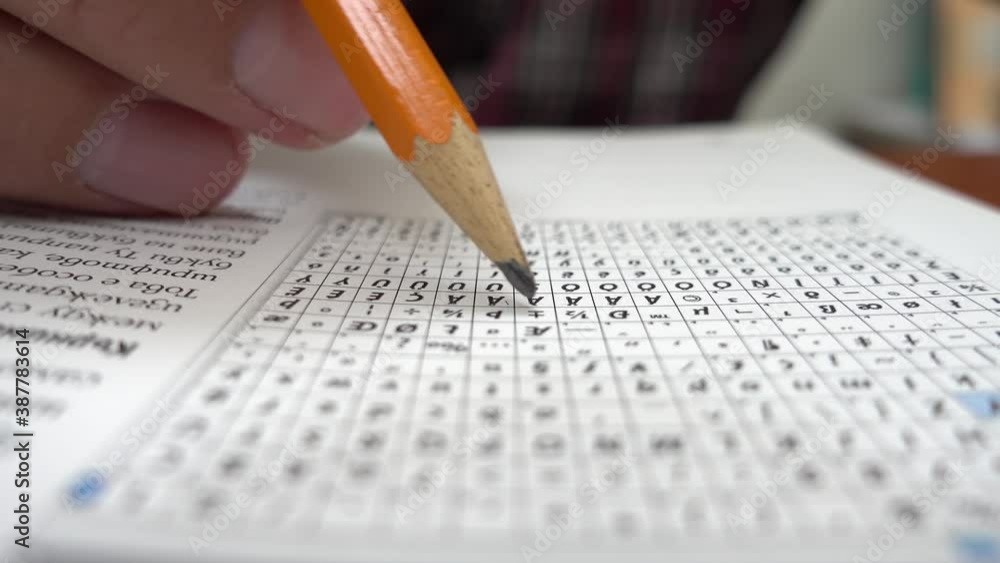 Young university student marking the important words from his lectures. Class notebook. Selective focus on example text book. Close up on student hands studying and doing homework. Young university student marking the important words from his lectures. Class notebook. Selective focus on example text book. Close up on student hands studying and doing homework.
