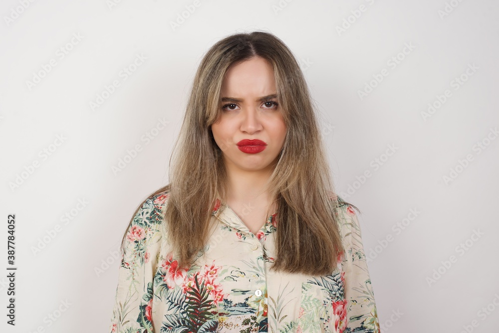 Portrait of outraged young woman with oval face, frowning her eyebrows being displeased with something. Portrait of outraged young woman with oval face, frowning her eyebrows being displeased with something.