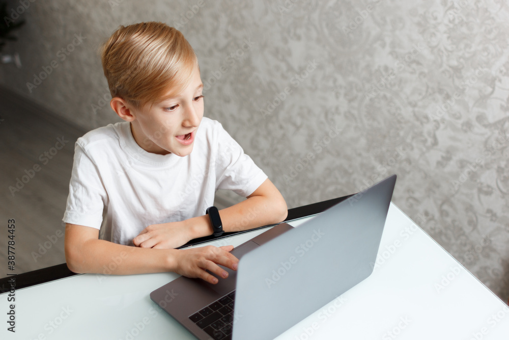 a child with a laptop performs homework for online training a child with a laptop performs homework for online training