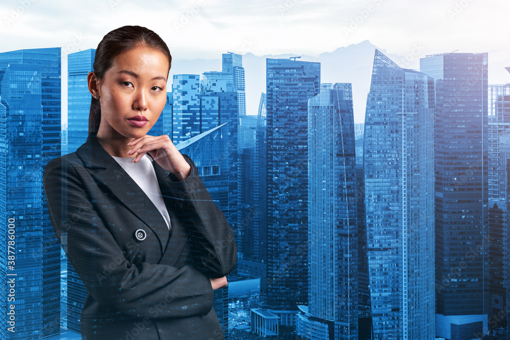 Attractive young Asian business woman in suit with hand on chin thinking how to succeed, new career opportunities, MBA. Singapore on background. Double exposure. Attractive young Asian business woman in suit with hand on chin thinking how to succeed, new career opportunities, MBA. Singapore on background. Double exposure.