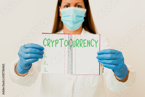 Word writing text Cryptocurrency. Business photo showcasing form of currency that exists digitally has no central issuing Laboratory technician featuring empty sticker paper accessories smartphone photo