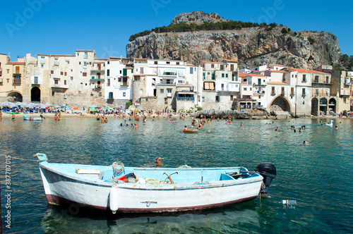 Characteristic view of the coastal city of Cefalù near Palermo in Sicily. It has a cristal clear blue water and nice old houses in front of the sea 