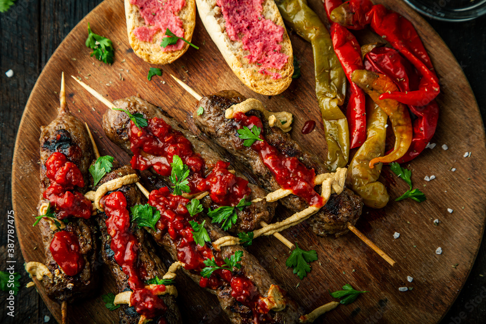 Grilled sausages and vegetables with  spices and fresh herbs