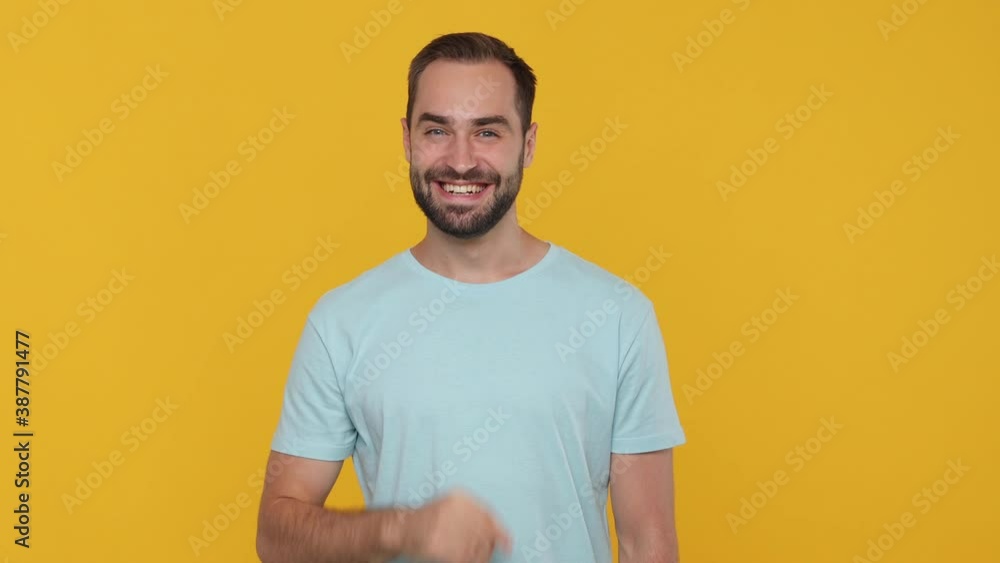 Bearded mysterious young man 20s in basic casual blue t-shirt isolated on yellow background studio. People emotions lifestyle concept. Looking camera say hush be quiet with finger on lips shhh gesture Bearded mysterious young man 20s in basic casual blue t-shirt isolated on yellow background studio. People emotions lifestyle concept. Looking camera say hush be quiet with finger on lips shhh gesture