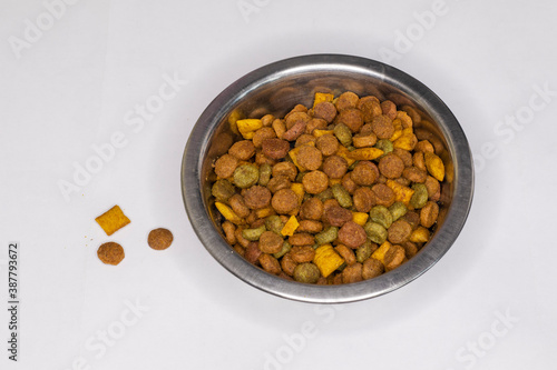 Dry cat food in a metal bowl.