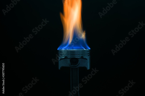 engine piston on fire on dark background
