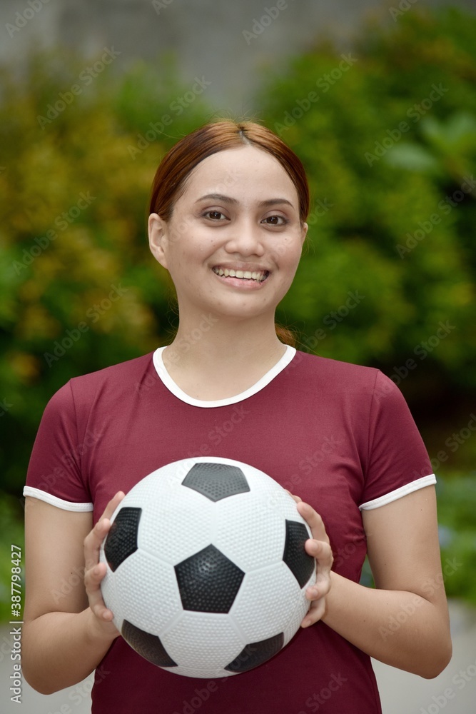 Smiling Athletic Redhead Female With Soccer Ball Outside
