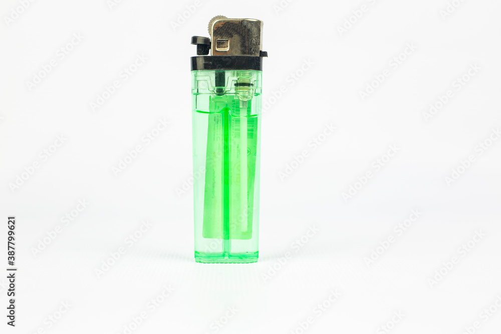 Green plastic gas disposable cigarette lighter isolated on white background with clipping path Green plastic gas disposable cigarette lighter isolated on white background with clipping path