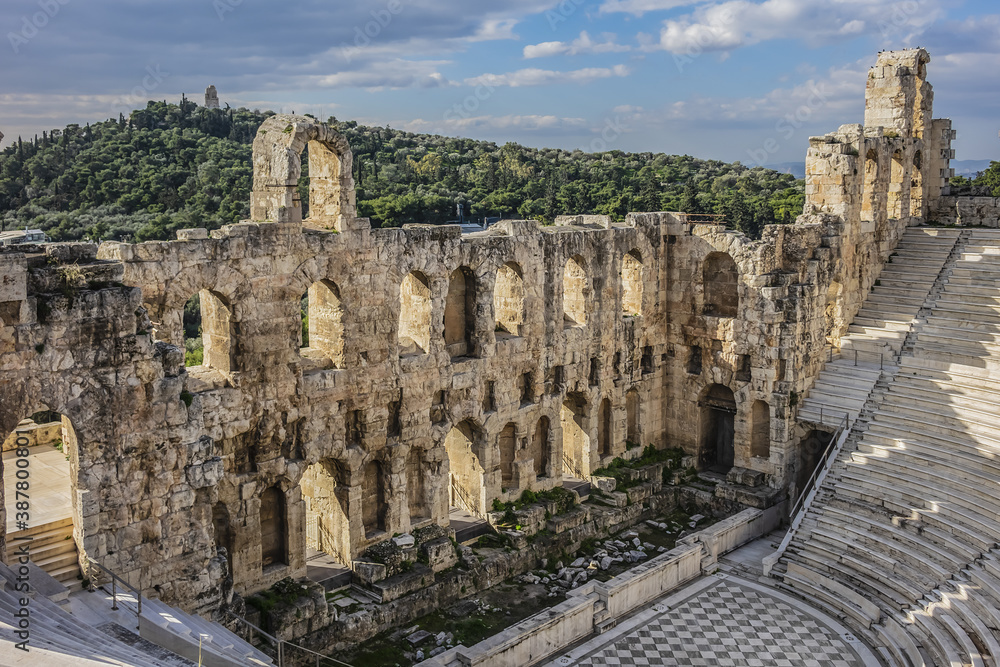 Fototapeta premium Top view of Greek ruins of Odeon of Herodes Atticus (161AD) - stone Roman theater at the Acropolis hill on sunset. Athens, Greece.