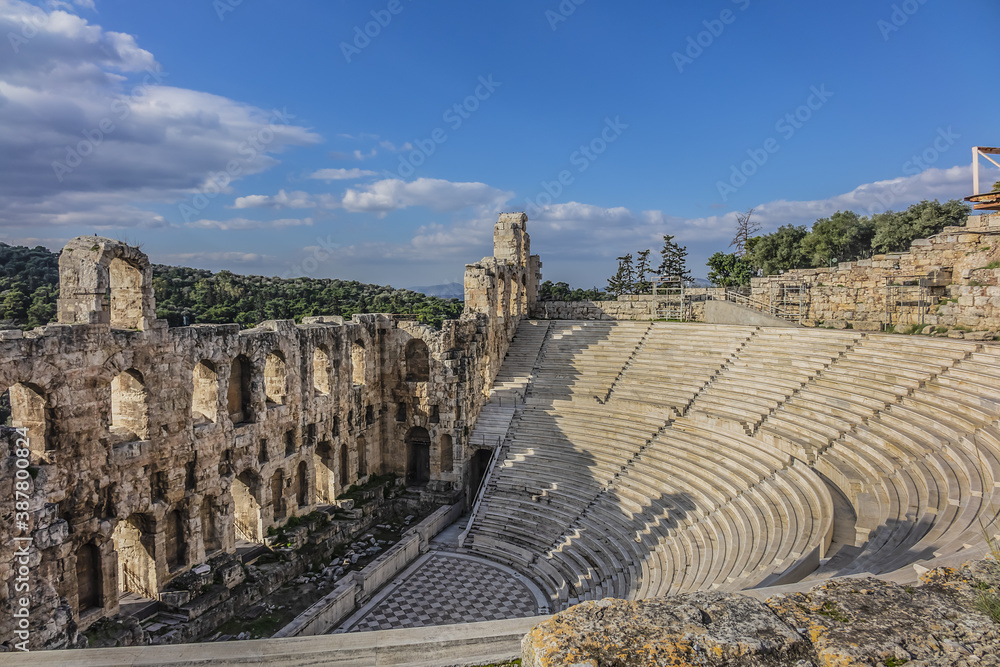Top view of Greek ruins of Odeon of Herodes Atticus (161AD) - stone Roman theater at the Acropolis hill on sunset. Athens, Greece.