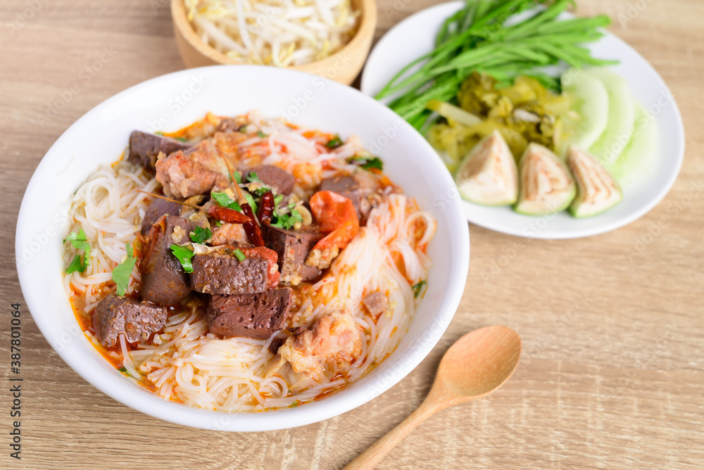Northern Thai food (Kanom Jeen Nam Ngeaw), Rice noodles spicy soup with pork and pork blood eating with fresh vegetables, Top view