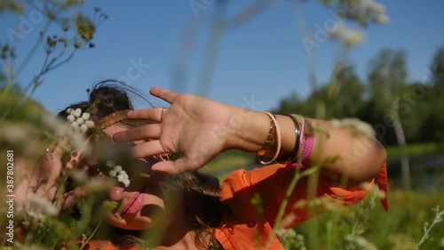 portrait of a happy smiling woman in sunglasses in a summer field. nature, summer vacation concept, vacations and people photo