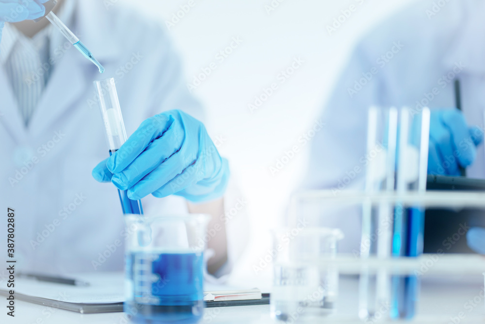 Scientists concentrate at result of chemistry experiment at laboratory. Scientists concentrate at result of chemistry experiment at laboratory.