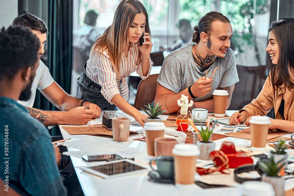 Business people meeting around a boardroom table discussing creative concept