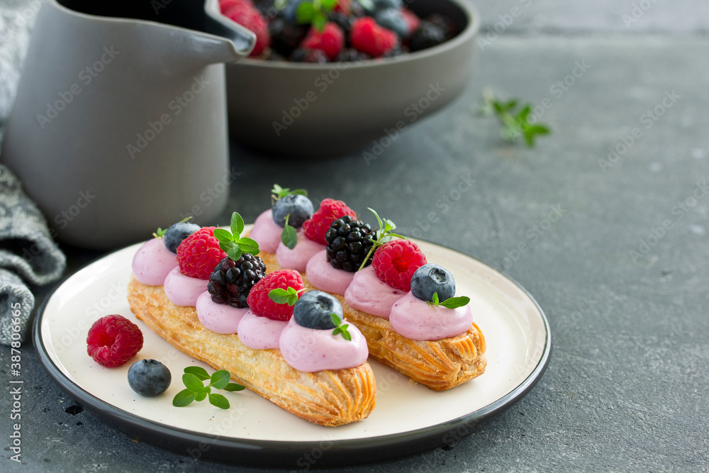 Homemade eclair with berry cream and fruits. . Pastry. Homemade eclair with berry cream and fruits. . Pastry.
