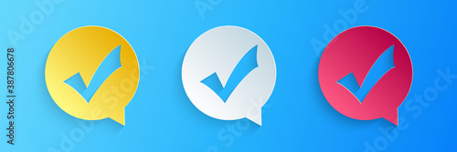 Paper cut Check mark in circle icon isolated on blue background Fototapeta