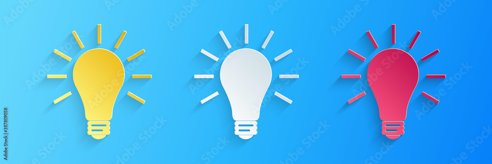 Paper cut Light bulb with rays shine icon isolated on blue background. Energy and idea symbol. Lamp electric. Paper art style. Vector. Paper cut Light bulb with rays shine icon isolated on blue background. Energy and idea symbol. Lamp electric. Paper art style. Vector.