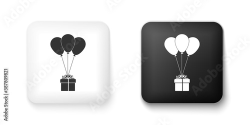 Black and white Gift box with balloons icon isolated on white background. Square button. Vector.