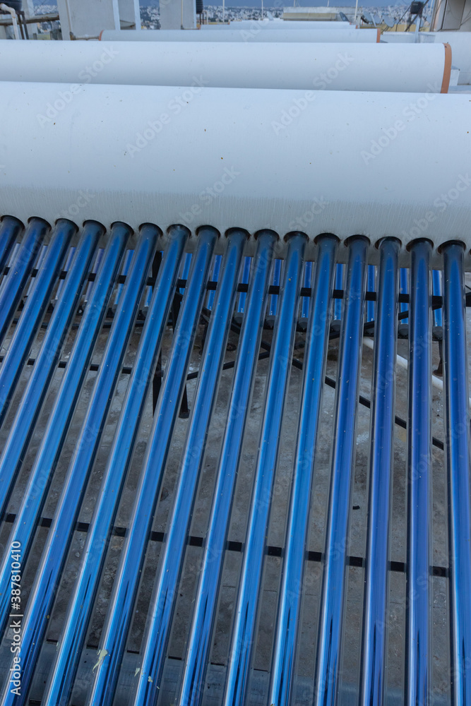solar panels and tubes installed on roof top of houses and buildings to conserve energy solar panels and tubes installed on roof top of houses and buildings to conserve energy