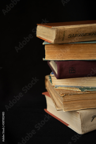stack of old books on black