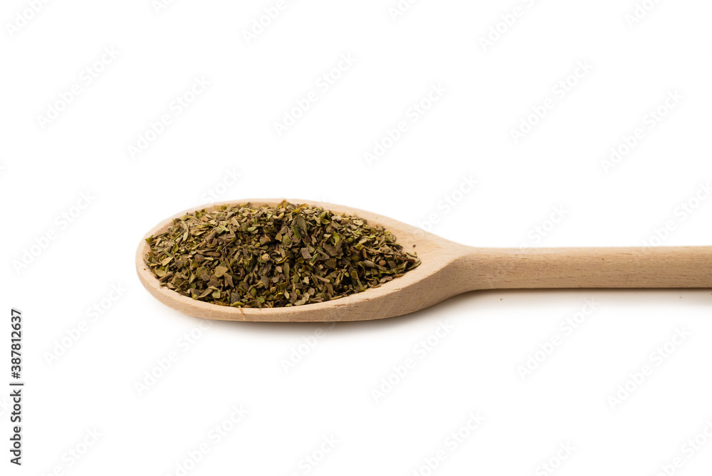 Oregano spice in wooden spoon isolated. Oregano spice in wooden spoon isolated.