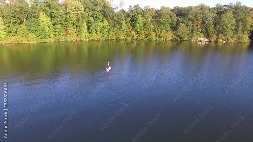 Boy Paddleboarding in late afternoon Boy Paddleboarding in late afternoon