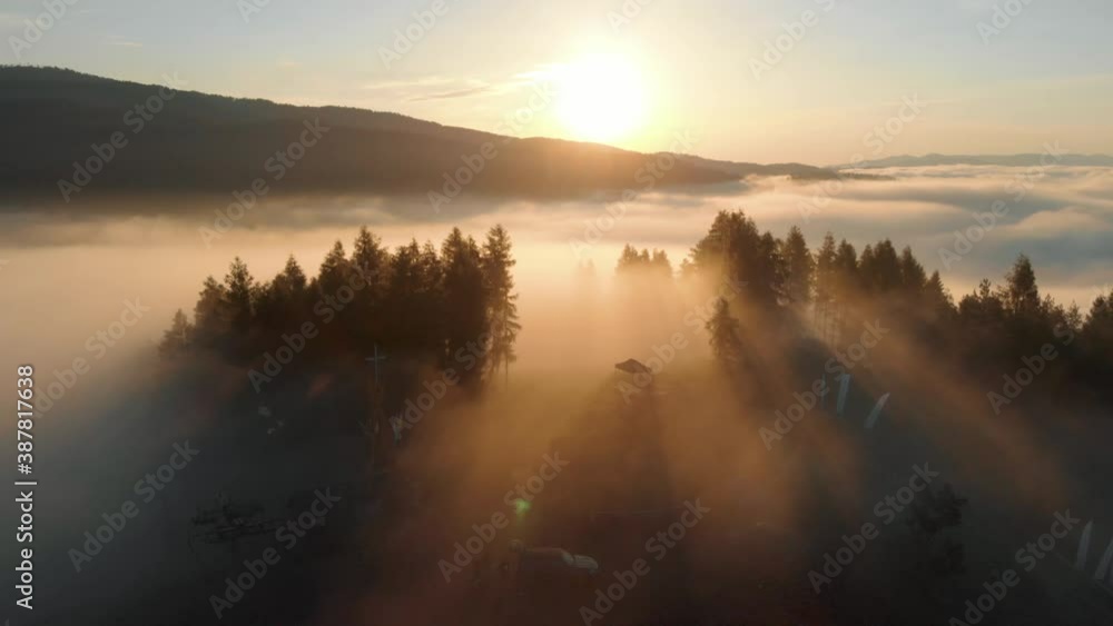 bright sun shining on clouds above forest bright sun shining on clouds above forest