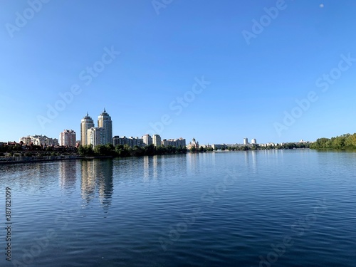 Dnipro river in Kyiv, Ukraine. Water, buildings, sky. Blue color. Obolon