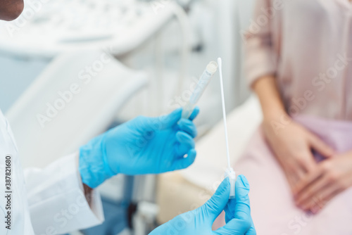 Gynecologist testing vaginal swab for STD