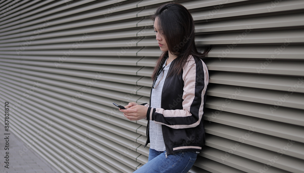 Pretty Asian woman relaxes in an urban area - people photography Pretty Asian woman relaxes in an urban area - people photography