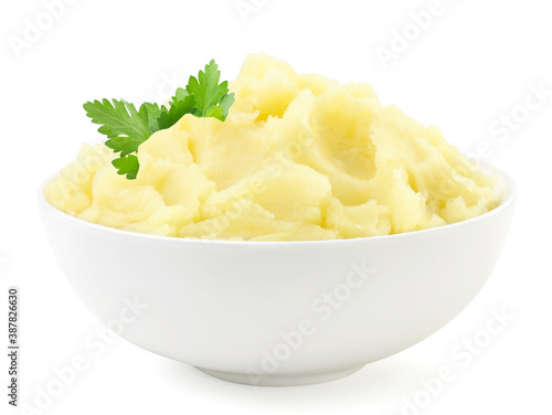 Foto Mashed potatoes with a parsley leaf in a plate on a white background