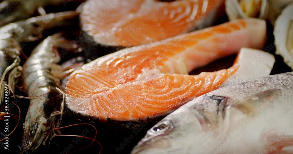 Salmon steaks and seafood on the table rotate. Salmon steaks and seafood on the table rotate.