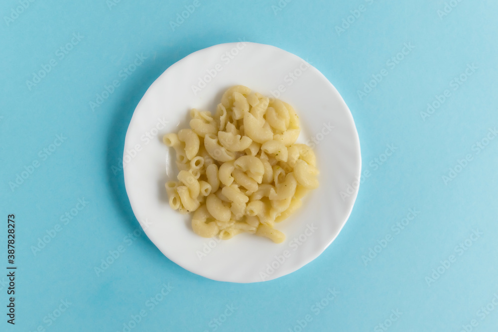 Funny Breakfast for children in the form of a bull's face made of pasta, sausage, bacon, olives and fresh tomatoes on a blue background. Instruction how to make creative food art breakfast for kids. Funny Breakfast for children in the form of a bull's face made of pasta, sausage, bacon, olives and fresh tomatoes on a blue background. Instruction how to make creative food art breakfast for kids.
