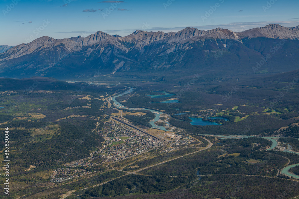 Town of Jasper Alberta, Canada from an aerial view and mountains and lakes in the distance