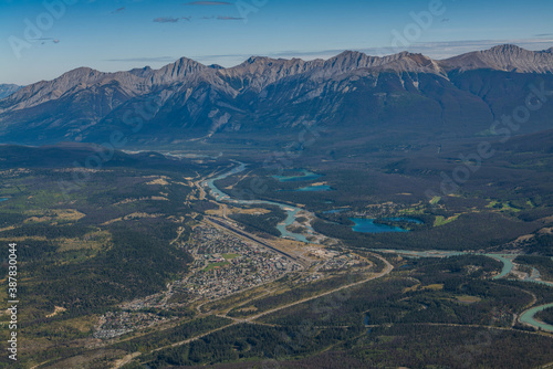 Town of Jasper Alberta, Canada from an aerial view and mountains and lakes in the distance