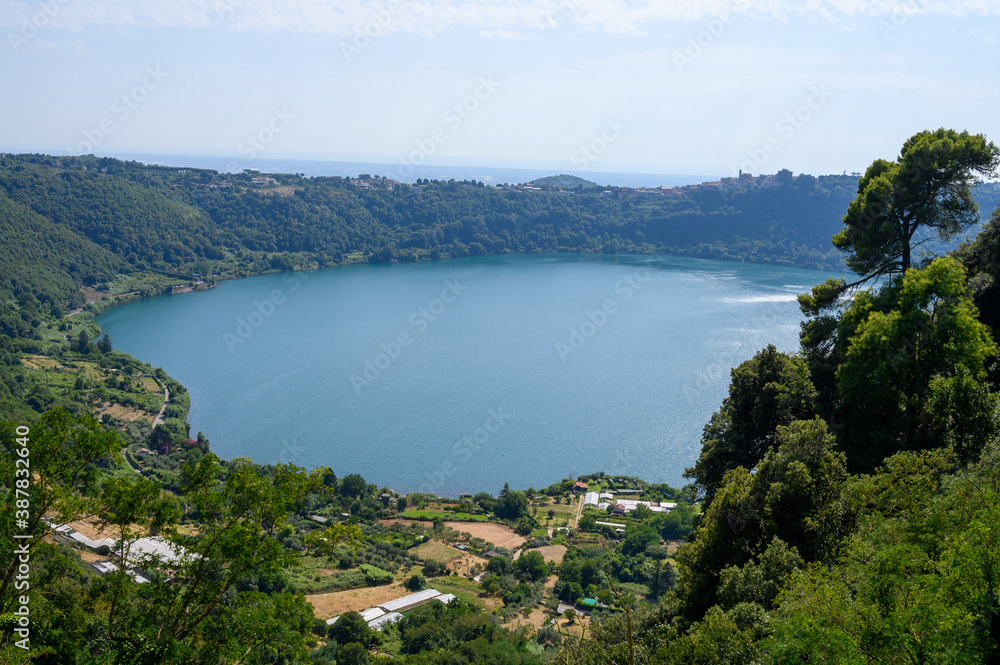 View on green Alban hills overlooking volcanic crater lake Nemi, Castelli Romani, Italy