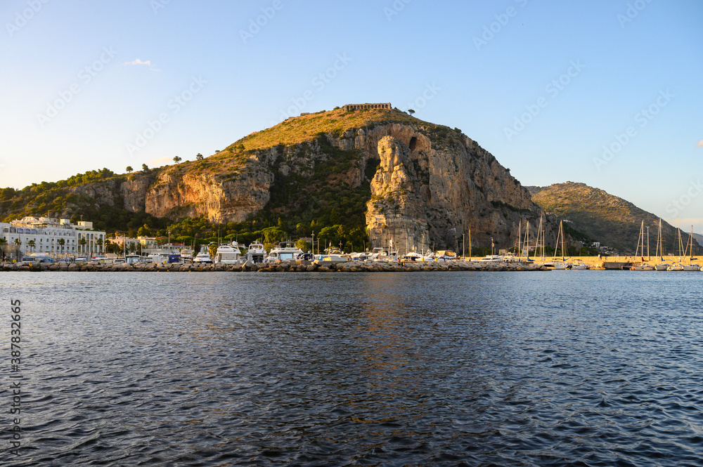 View on medieval small touristic coastal town Terracina and sea shore, Latina, Italy on sunset