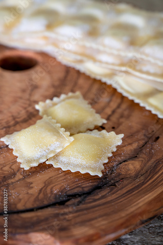 Handmade uncooked fresh ravioli with four cheeses filling, tasty vegetarian food
