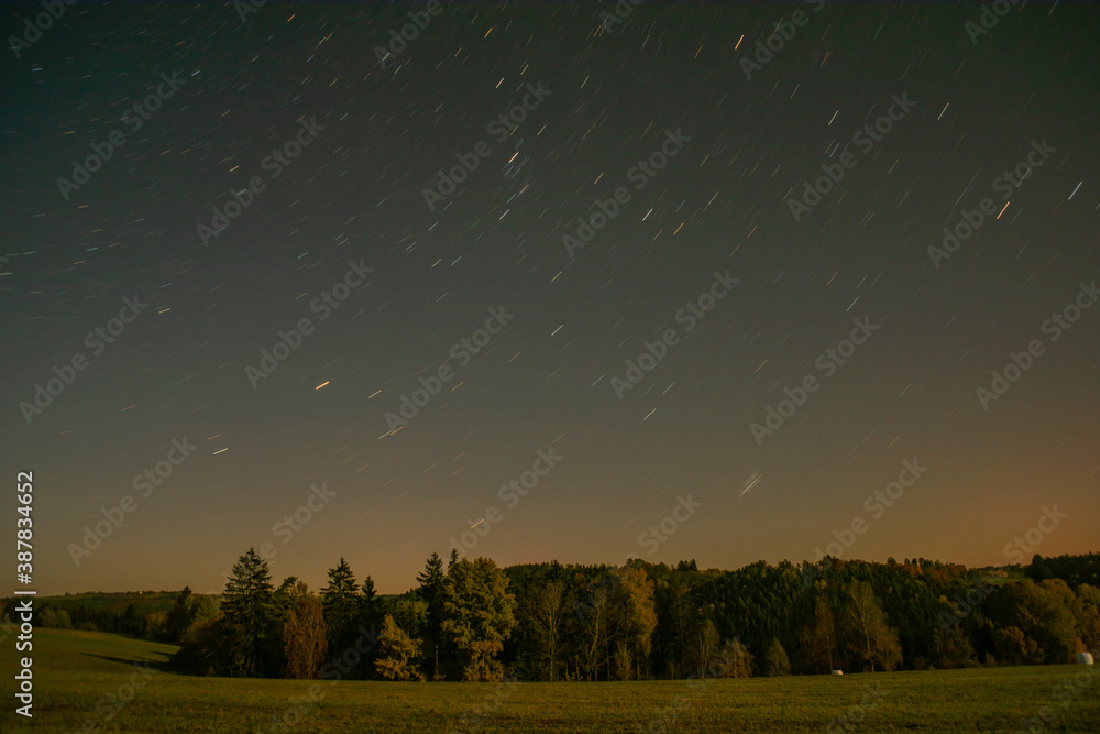 Dark blue sky with stars and moonshine on pasture land and field near Utery town